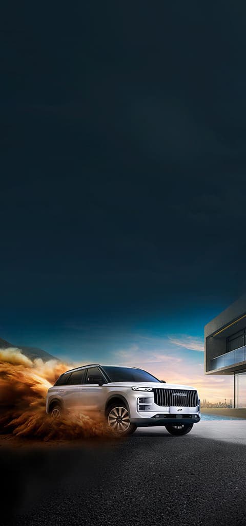 Jaecoo J7 kicking up sand at dusk
