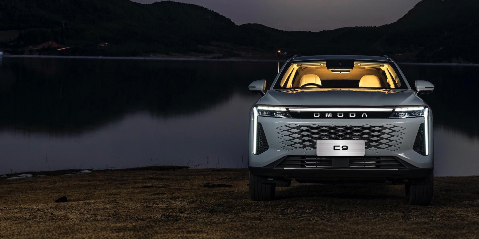 Omoda C9 at a lakeside at night